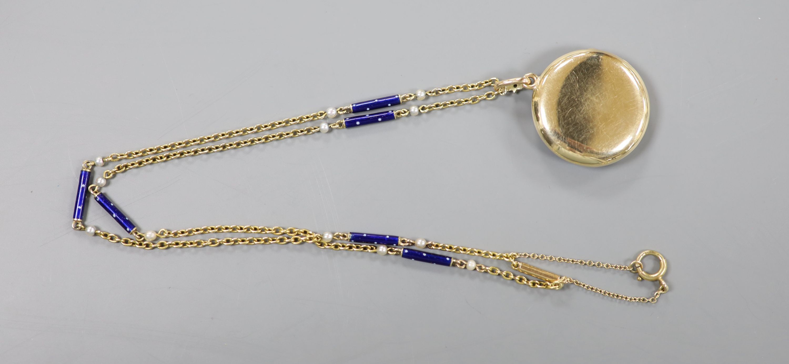 A yellow metal, blue enamel and rose cut diamond set monogrammed circular locket (a.f.) 29mm, on a 9k, seed pearl and blue enamel baton link chain, 48cm